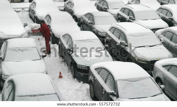 New car\
showroom. New cars are covered a\
snow.