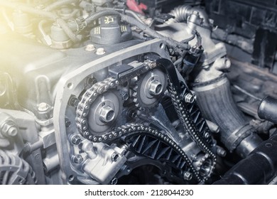 New car timing chain on a diesel old engine in a car workshop. Close up. Blur effect. - Shutterstock ID 2128044230
