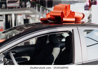 The New Car Is Wrapped In A Red Bow. Beautiful Gift Concept 