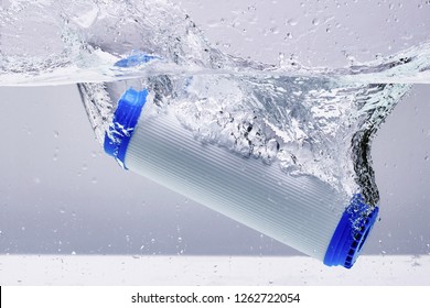 New carbon filter cartridge for house water filtration system isolated on white background. Splash. Concept.