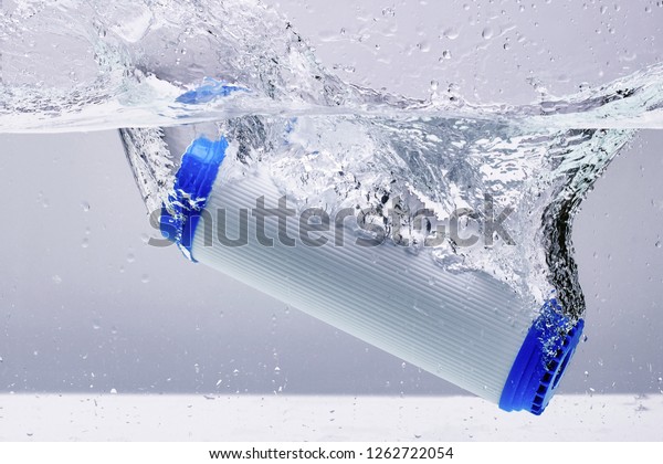 New carbon filter\
cartridge for house water filtration system isolated on white\
background. Splash.\
Concept.