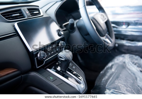 New cars in the luxury car interior\
showroom Steering wheel, gear lever and control\
panel