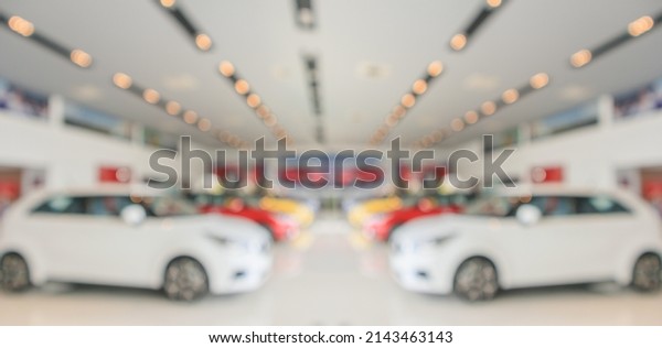 new\
cars in showroom interior blurred abstract\
background