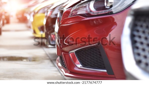 New cars in showroom for sale. Cars Dealership\
parking lot. Automotive\
Industry.