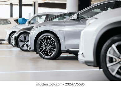 New cars in the showroom show waiting for sale to customer. Luxury modern cars for sale. Cars waiting for sales of branch dealers and new car service center.