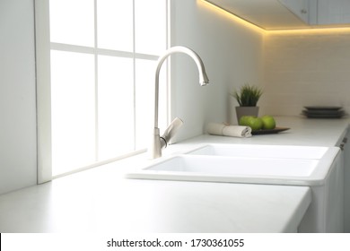New ceramic sink and modern tap in stylish kitchen interior - Shutterstock ID 1730361055
