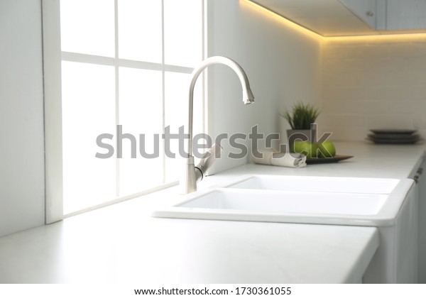 New ceramic sink and modern tap in stylish
kitchen interior