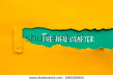 The new chapter message written on ripped torn yellow paper with blue background. Conceptual the new chapter symbol. Copy space.