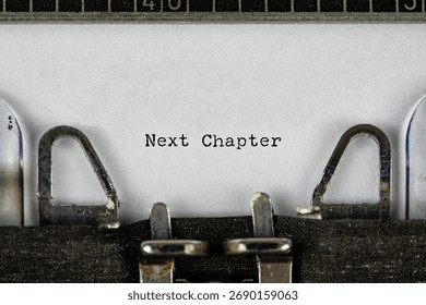 New Chapter phrase close up being typing and centered on a sheet of paper on old vintage typewriter mechanical