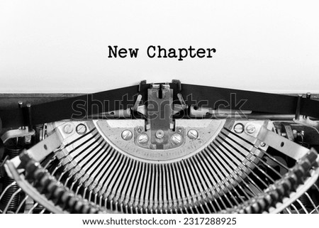 New Chapter phrase close up being typing and centered on a sheet of paper on old vintage typewriter mechanical