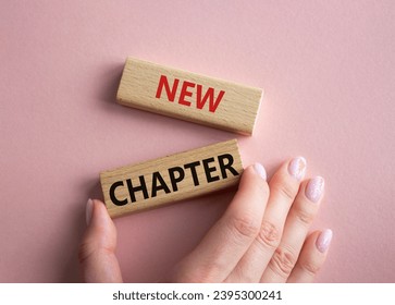 New Chapter symbol. Concept word New Chapter on wooden blocks. Businessman hand. Beautiful pink background. Business and New Chapter concept. Copy space - Shutterstock ID 2395300241