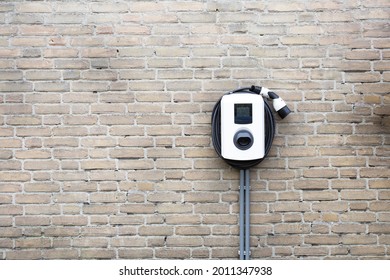 New charging station for electric car on brick wall at home, charging pillar with copy space , space for text - Shutterstock ID 2011347938