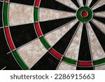 New classic professional sisal dart board on black wooden background. Close up
