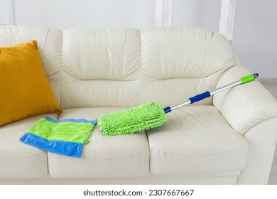 New clean green microfiber mop floor wiper cleaning sweeping tool lying on sofa - tools for cleaning services and domestic work housekeeping - Powered by Shutterstock