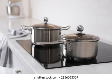New clean pot and saucepan on cooktop in kitchen