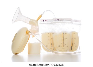 New compact electric breast pump to increase milk supply for breastfeeding mother and bags of frozen breastmilk isolated on white background