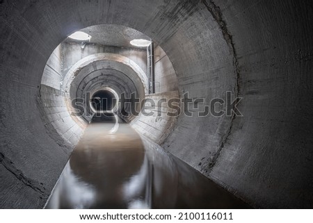 New concrete drainage rainwater collector, in a concrete pipe, inside view.
