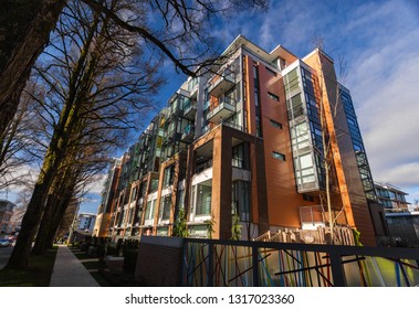 New Concrete Low Rise Apartment Building On Sunny Day.