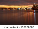 A new condominium development at twilight on the banks of the Fraser River in Richmond, British Columbia, Canada near Vancouver. A large sports and recreation complex is in the background.