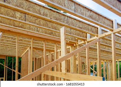 New construction of beam construction house framed the ground up framing against a blue sky