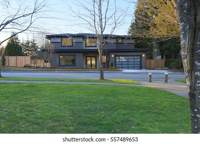 New Construction Home Exterior With Contemporary House Plan  Features Low Slope Roof, Brown Siding And Glass Garage Door. Northwest, USA