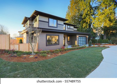 New Construction Home Exterior With Contemporary House Plan  Features Low Slope Roof, Brown Siding And Glass Garage Door. Northwest, USA