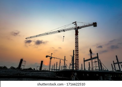 New construction site with crane and mechanical equipments on sunset background. - Powered by Shutterstock