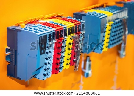 New control panel with electrical equipment. Automatic power switches. Industrial Automation. Industrial controllers and HMI. Multi-colored electrical background.