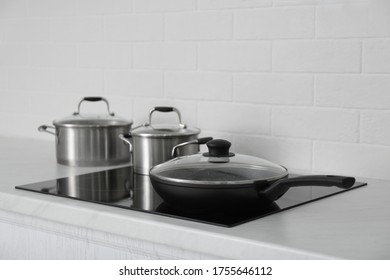 New Cookware On Induction Stove In Kitchen