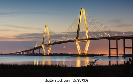 New Cooper River Ravenel Bridge in Charleston, South Carolina, illuminated at dusk.