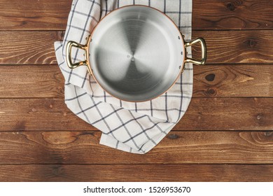 New Copper Cooking Pot On Wooden Table, View From Above