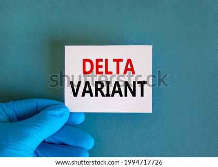 New covid-19 delta variant strain symbol. Doctor hand in blue glove with white card. Concept words 'delta variant'. Medical and COVID-19 delta variant strain concept. Copy space.