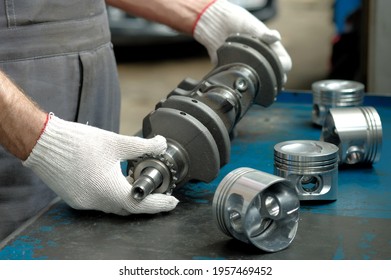 New crankshaft close-up. A set of engine pistons on the car mechanic's desktop. Quality control of spare parts. Car engine repair. - Shutterstock ID 1957469452