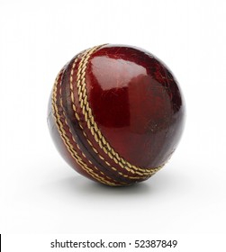 A new cricket ball on a white background showing stiching.