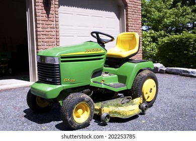 New Cumberland, PA, USA - May 21, 2011 :John Deere Lawn Mower In Front Of Modest Home