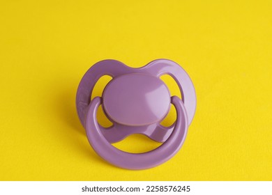 New cute baby pacifier on yellow background - Shutterstock ID 2258576245