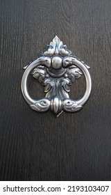 New Decorative Round Metal Door Knocker On Wood Door Closeup
