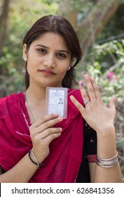 New Delhi - APRIL 23, 2017: New Delhi Elections 2017
A Woman Shows Her Ink Stained Index Finger And Voter Card After Casting Her Vote For The MCD Elections 2017 At A Polling Booth In New Delhi, India.