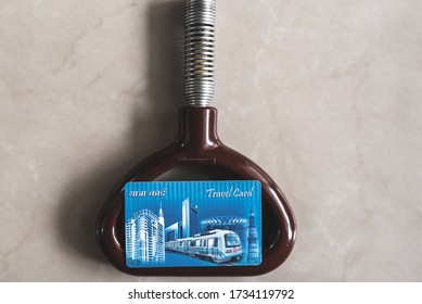 New Delhi, Delhi, India - 07/20/2019: Close Up Of Tube Travel Card Placed On Top Of Metal Passenger Spring Handle. Delhi Metro Smart Card For Easy Access Popular With Office Goers And Daily Commuters.