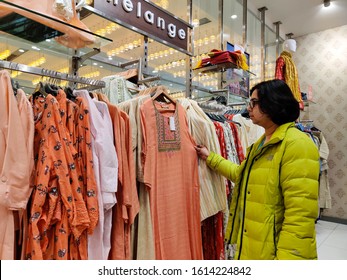 New Delhi, India, 2019. A Young Indian Woman Checking Designer Kurta ( Salwar Kamiz) On Display At A Shopping Mall In New Delhi, India