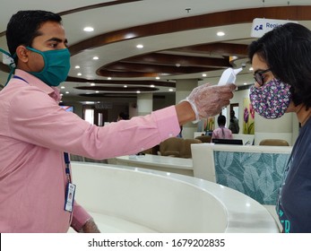 New Delhi, India, 2020. People Getting Checked By Healthcare Worker Doing Mandatory Thermal  Temperature Scan During Corona Virus (covid-19) Pandemic In An Indian Private Hospital. 