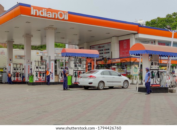 New Delhi, India, 2020. Petrol / Diesel being\
filled into a car at an Indian Oil Petrol Pump to get tank full and\
pollution checking centers to get PUC. Price hike is considered\
indicator of economy