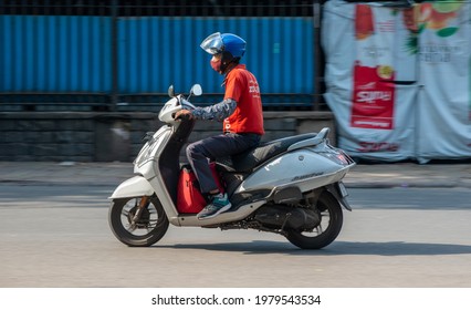 New Delhi, India, 21 May 2021: Zomato Food Delivery Boy On Two Wheeler, Going To Food Delivery, Zomato An Indian Multinational Restaurant Aggregator And Food Delivery Company.