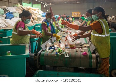 New Delhi, India- 23 September 2019, Woman Workers Separating Paper And Plastic On A Conveyor Belt In A Recycling Facility In India.