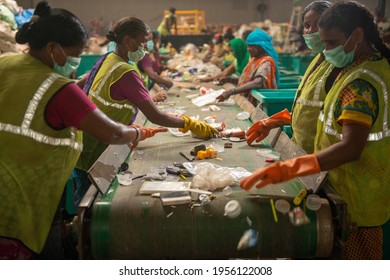 New Delhi, India- 23 September 2019, Woman Workers Separating Paper And Plastic On A Conveyor Belt In A Recycling Facility In India.