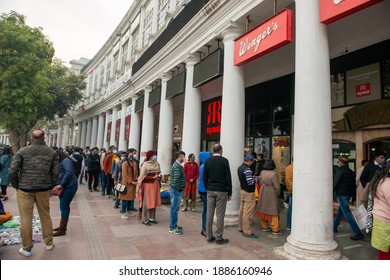  New Delhi, India, 31 December 2020: A Huge Crowd Of People Stand In Queue Outside Wenger's A Famous Bakery Shop In Connaught Place.