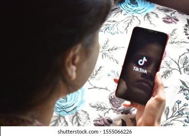 New Delhi, India - 9 November 2019: Face Reflection On Phone,tik Tok App Using By Girl Concept