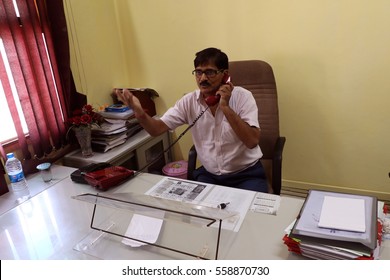 New Delhi, India - April 2, 2016: An Unidentified  Senior Offecial Chatting On Land Line Telephone In His Office.