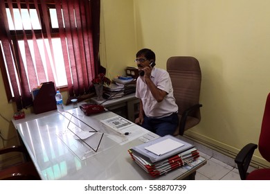 New Delhi, India - April 2, 2016: An Unidentified  Senior Offecial Chatting On Land Line Telephone In His Office.