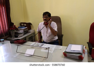 New Delhi, India - April 2, 2016: An Unidentified  Senior Offecial Chatting On Land Line Telephone In His Office.